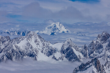 View of snow mountain glaciers at the high altitude in the Alps. Stunning mountain landscape with high snow peaks and summits of Mont Blanc mountain range from Aiguille du Midi summit