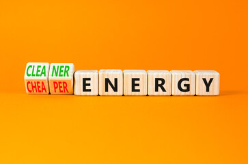 Cleaner or cheaper energy symbol. Concept words Cleaner energy Cheaper energy on beautiful wooden blocks. Beautiful orange background. Business Cleaner or cheaper energy concept. Copy space.