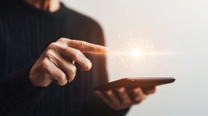 A person is pointing at a tablet with a glowing light on it. Concept of curiosity and wonder, as the person is likely exploring the tablet's features or content