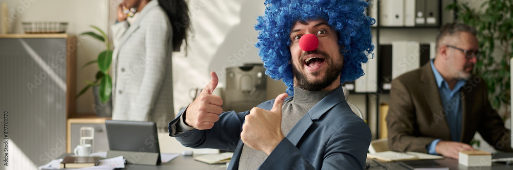 Poster header of young successful office worker in clown wig and nose looking at camera and showing thumbs 