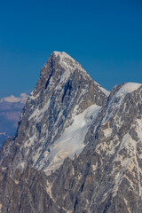 View of snow mountain glaciers at the high altitude in the Alps. Stunning mountain landscape with high snow peaks and summits of Mont Blanc mountain range from Aiguille du Midi summit