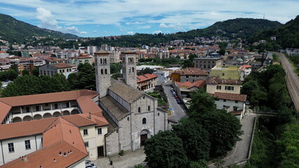 bird aerial view of Sant'Abbondio cathedral in Como Romanesque-style time with old city and lake in backbround