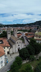 bird aerial view of Sant'Abbondio cathedral in Como Romanesque-style time with old city and lake in backbround