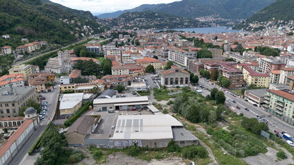 bird aerial view of Sant'Abbondio cathedral in Como Romanesque-style time with old city and lake in backbround