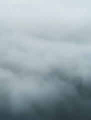 Obraz premium Misty clouds envelop mountain peak; mysterious and ethereal atmosphere