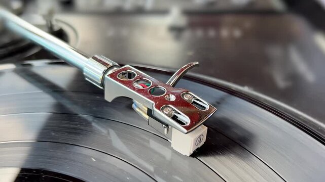 Close up selective focus on Vinyl player on long play or LP which rotates on a platter of a turntable.