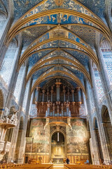 Fototapeta premium Majestic Interior of Sainte-Cecile Cathedral in Albi, France with Ornate Blue Vaulted Ceilings and Historical Murals