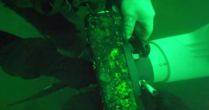 Commercial divers repairing oil pipes underwater