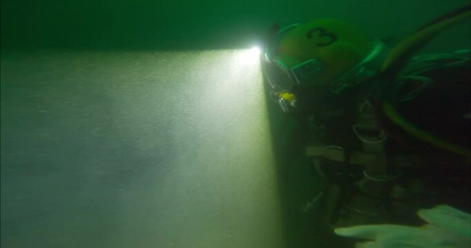Commercial diver using headlight to navigate closeup