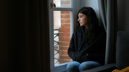 thoughtful pensive woman staring outside melancholically
