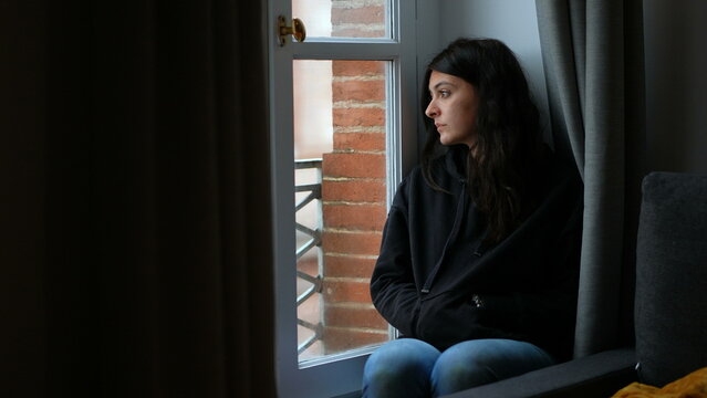 thoughtful pensive woman staring outside melancholically