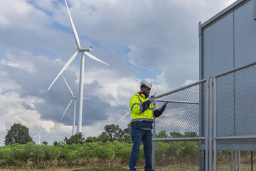 Survey Team Alternative energy for future. Engineers survey and checking wind turbines in sunset. Wind Turbine Renewable energy technology and sustainability.