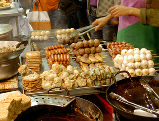 Kebabs and hot snack food for sale on night street stall in Mong Kok area of Kowloon, Hong Kong, China