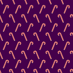 Small candy canes isolated on dark blue purple background. Seamless pattern. Vector simple flat graphic illustration. Texture.