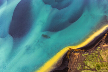 Aerial view of Olfusa River in South Iceland showcasing vivid turquoise and yellow hues...
