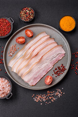 Fresh raw bacon sliced with spices and herbs
