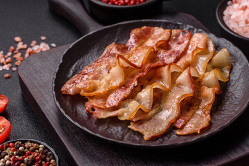 Delicious bacon in the form of slices with salt, spices and herbs