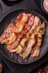 Delicious bacon in the form of slices with salt, spices and herbs