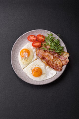 A hearty breakfast with fried eggs, bacon, tomatoes, microgreens