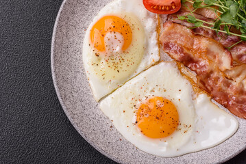 A hearty breakfast with fried eggs, bacon, tomatoes, microgreens