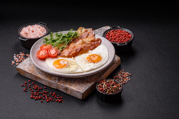 A hearty breakfast with fried eggs, bacon, tomatoes, microgreens