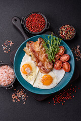 A hearty breakfast with fried eggs, bacon, tomatoes, microgreens