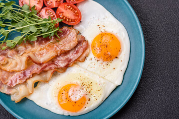 A hearty breakfast with fried eggs, bacon, tomatoes, microgreens