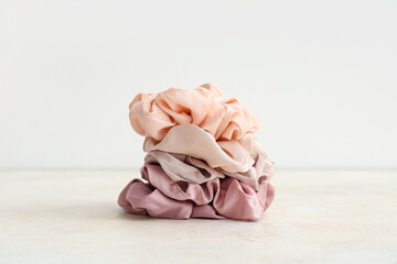 Trendy silk scrunchies on white background
