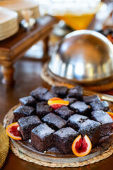 Chocolate cake with orange garnish.