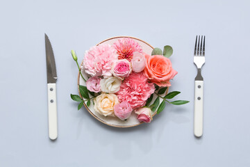 Stylish table setting with beautiful floral composition on grey background