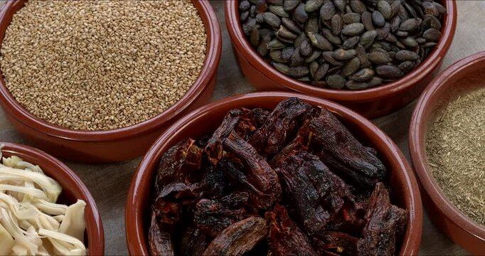 Ingredients for homemade vegan Mexican sauce Pipian Tlatonile: toasted sesame seeds (unhulled) and pumpkin seeds, toasted dried chilies, epazote, and salt. Table spin. 