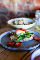 Burrata toast with arugula and roasted tomatoes