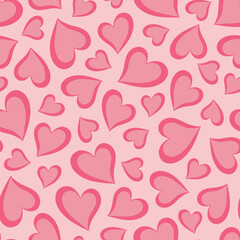 Seamless pattern with pink hearts on a light pink background. Valentine's day background.