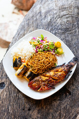 Grilled fish, noodles, rice, and bananas