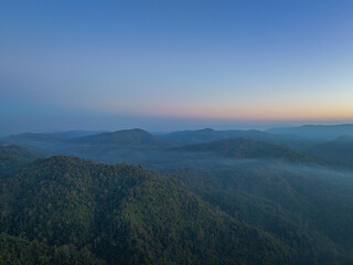Aerial View of beautiful sunrise above the mist in the valley..There is a sweet sky on the horizon caused by the radiant light of the sun..colorful sky of sunrise