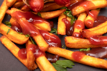 Close up of a french fries covered with sauce