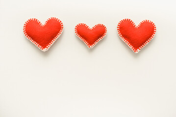 Red felt hearts. Handmade red hearts. Red hearts background. Valentine's Day background.