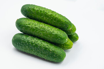 Fresh green cucumbers on a white background