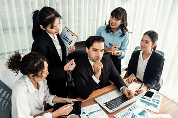 Diverse group of business analyst team analyzing financial data report paper on office table. Chart and graph dashboard by business intelligence analysis for strategic marketing planning Meticulous