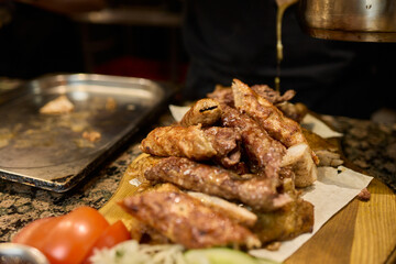 Enjoying Delicious Chicken Wings Accompanied by Fresh Sides and Tasty Sauces for All