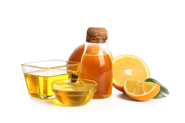 Bottle and glass bowls of orange essential oil with fresh fruits on white background