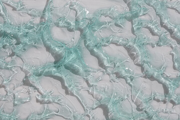 Cream gel gray blue transparent cosmetic sample texture with bubbles on white background