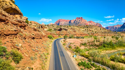 Aerial of Winding Road and Red Rock Cliffs in Utah Desert
