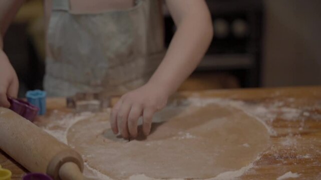 Baking cookies in a cozy kitchen with rolling dough and colorful cutters