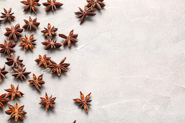 Many anise stars on grey background