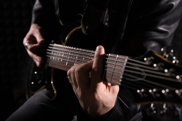 Electric guitar playing. Young men playing electric guitar