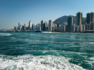 Naklejka premium Panoramic view from the sea to the city in Hong Kong. Cityscape, skyscrapers