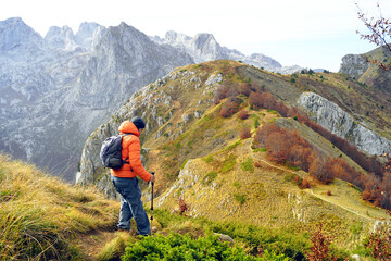 Active recreation in the most beautiful places of Montenegro: a man walks along a path with a...