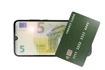 Green plastic credit card lies on a 5 euro banknote on a transparent background (close-up). Online credit card payment for purchases in online stores