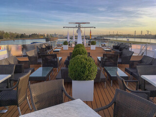 Modern sun loungers and deck chairs with lounge furniture on outdoor terrace patio sun deck of elegant river cruiseship cruise ship liner on Rhine